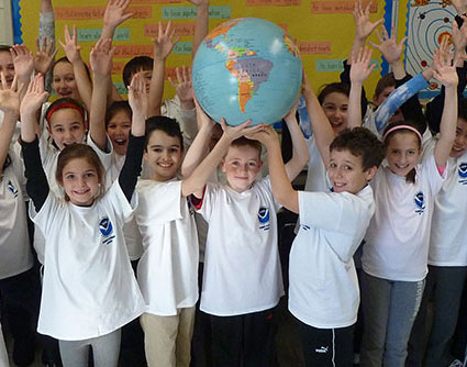 children holding up a globe