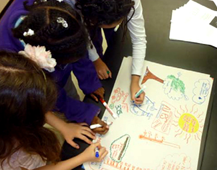 Students coloring on poster board