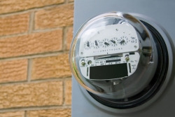 An electromechanical electric meter on the side of a house. | Photo courtesy of Â©iStockphoto/epantha
