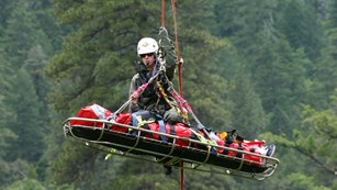 Ranger on a litter suspended in the air