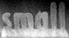 The crystallized oxide (lighter regions) spelling the word “small” was “printed” on a non-crystallized layer (darker gray) by a well-controlled beam in an electron microscope.