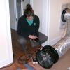 A technician conducts a duct blaster test