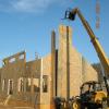 A crane is used to install the SIP fireplace chimney chase