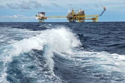 Offshore platform with waves in foreground