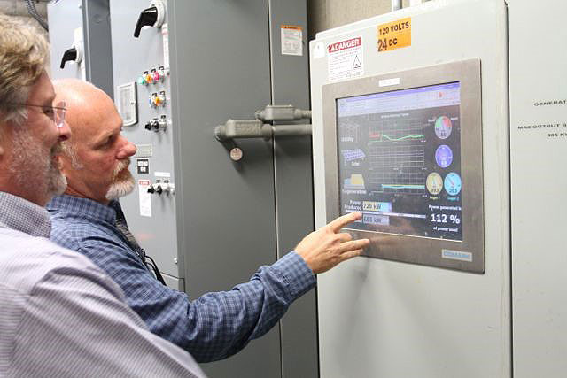 Alan Johnston shows me the treatment plant is generating 112% of their total energy demand at that moment. Photo credit: Jim Swenson, New Media Magic LLC 