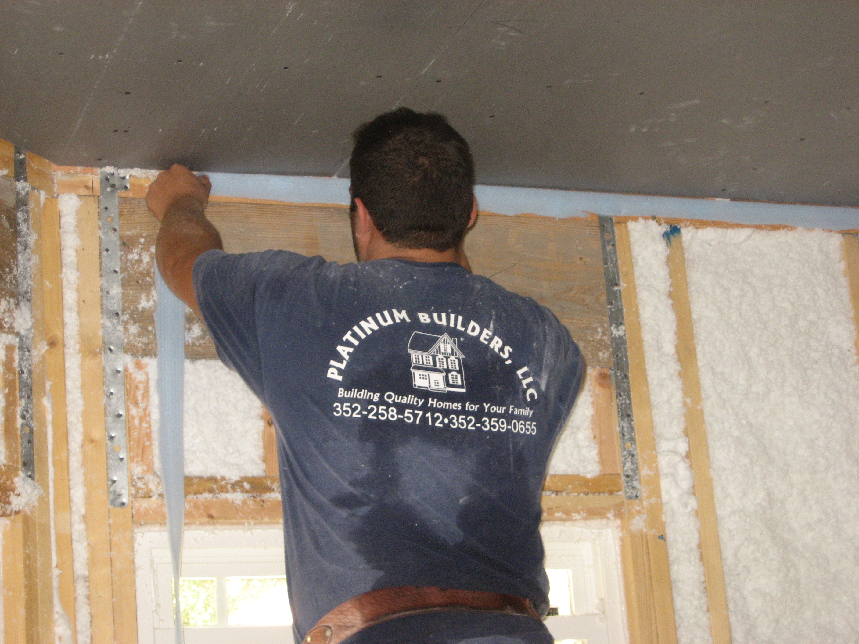 Install a foam gasket along top plates before installing drywall