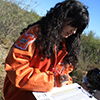 Samantha Gonzalez documents forage weights during an Earth Team video shoot.