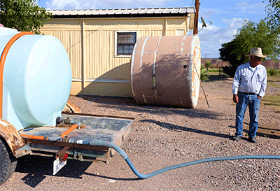 Victor Manuel Juarez, a Las Pampas colonia resident filling up his 500-gallon water tank at water pump station in Presidio County, TX