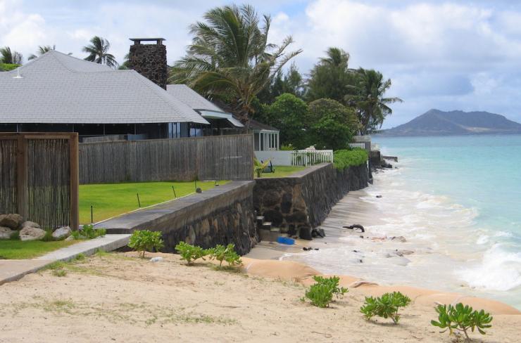 Coastal homes with rock seawalls and very little beach sand