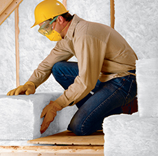 man installing insulation