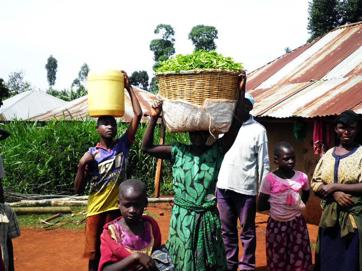 Villagers carry water jug and food basket