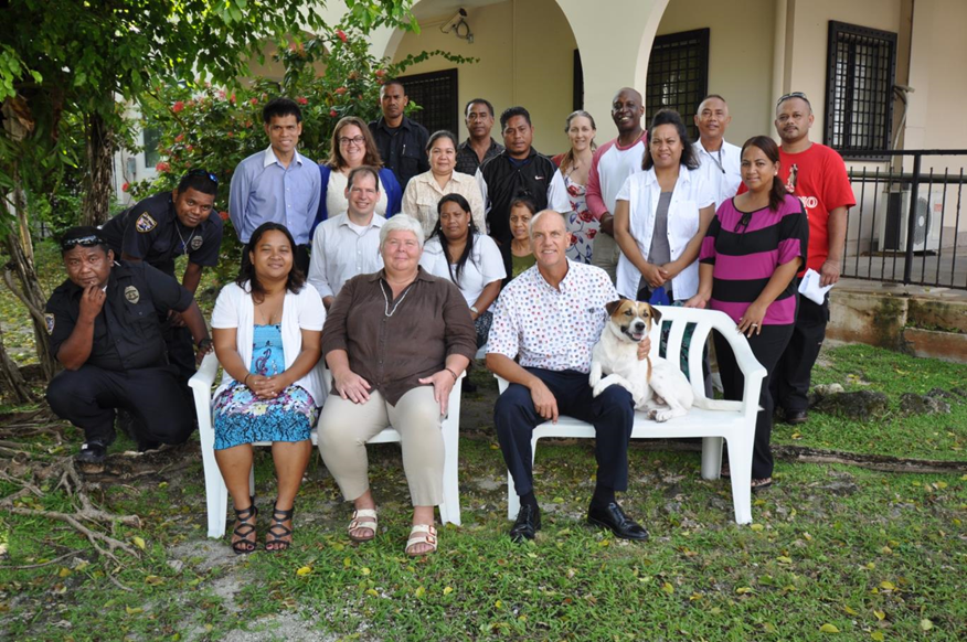 A team of people (an a dog!) pose for a photo