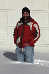 Jeffrey Levy stands in knee-deep snow
