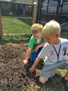 Teagan Scheurer and Levi Boyer plant pumpkin seeds at the Early Childhood Learning Center. Children will also help harvest the vegetables from their seeds.