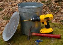 Tapping supplies for maple sugaring: drill, hammer, tap and container