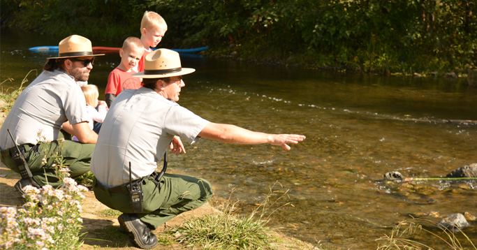 Park rangers teach children visiting the Winters Salmon Festival about Putah Creek