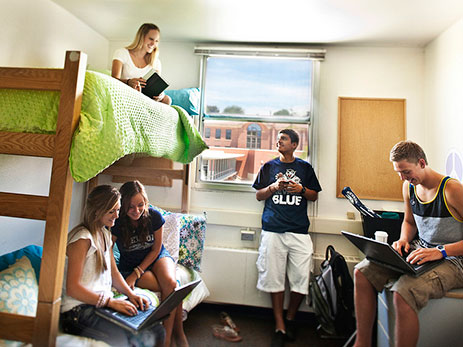 Photo of students in the living room of the living learning community