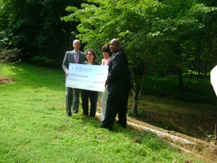 Drew Becher (President, Pennsylvania Horticultural Society), Julie Slavet (Executive Director, Tookany/Tacony-Frankford Watershed Partnership, Inc.), Barbara McCabe (Director of Stewardship, Philadelphia Parks & Recreation, and William C. Early (Deputy Regional Administrator, U.S. Environmental Protection Agency, Region III) with the Urban Waters small grant “big check” at Friends Hospital in Northeast Philadelphia.