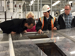 Here, Joel Beauvais peeks into the settling chamber of the package water treatment system