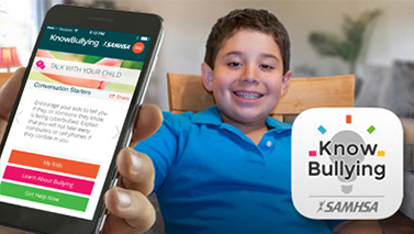 Cell phone with Knowbullying app open and a smiling boy on the background. 