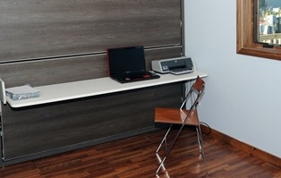 Photo of a laptop and printer in a home office. Photo courtesy of Thomas Kelsey/U.S. Department of Energy Solar Decathlon