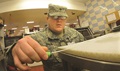 Army Spc. Tyler Davis, Fort Lee Veterinary Services, uses a swab to test a food preparation area for bacteria at the Defense Commissary Agency store here recently. Davis, a veterinary food inspection specialist, is part of the effort that ensures food safety and security on installations all over the world. (U.S. Army photo by T. Anthony Bell)