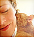 Orange cat nuzzling woman 