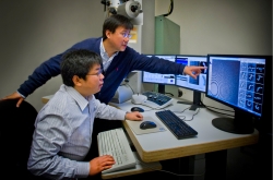 Gang Ren and Lei Zhang at Berkeley Lab's Molecular Foundry were part of a team that found new evidence to explain how cholesterol is moved from HDLs to LDLs. | Photo by Roy Kaltschmidt, Berkeley Lab