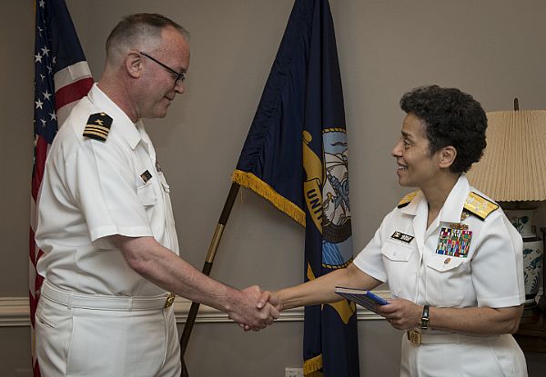 WASHINGTON (May 27, 2016) Adm. Michelle Howard, then Vice Chief of Naval Operations (VCNO), recognizes Lt. Cmdr. Jeffrey Jacobson just prior to his promotion to commander in a ceremony at the Pentagon. Howard served as Jacobson's promoting officer. Howard and Jacobson are high school classmates. They graduated from Gateway High School in Aurora, Colorado in 1978. U.S. Navy photo by Mass Communication Specialist 2nd Class George M. Bell.