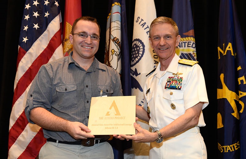 NATIONAL HARBOR, Md. (May. 16, 2016) Aviation Electronics Technician 1st Class Michael Pecota of Fleet Readiness Center Mid-Atlantic, Detachment Patuxent River, Maryland, receives the Admiral Sims Award for Intellectual Courage from Vice Adm. Philip Cullom, deputy chief of naval operations for fleet readiness and logistics, during the Athena D.C. 1.0 Challenge--a "Shark Tank"-inspired event to discover innovative ideas from Sailors and Marines. The event was held during the Sea-Air-Space Exposition. U.S. Navy photo by John F. Williams/Released


