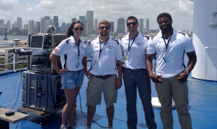 The research team installs the terminal on the crew deck of Norwegian Sky for the cruise ship demonstration. From left to right are Kristen Nock, NRL; Chris Smith, NRL; Adam Jaffe, MC; and Jeremy Keyes, MC. Photo by U.S. Naval Research Laboratory. 