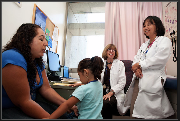 Nurses from the Alliance of Nurses for Healthy Environments (ANHE) talking with a mother and a child.