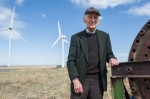 NREL Senior Engineer Palmer Carlin at the National Wind Technology Center, flanked by some of the massive turbines he says early wind technology pioneers only dreamed of seeing. | Photo by Dennis Schroeder