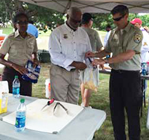 Dr. Tuggle helps prepare catfish at the Steve Harvey event