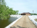 Construction of a berm to protect the Mni Wiconi Rural Water System raw water pump station. June 2011.