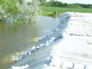 Construction of a berm to protect the Mni Wiconi Rural Water System raw water pump station. June 2011.