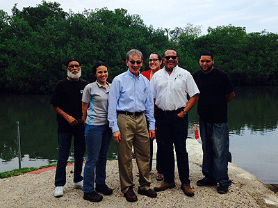 Deputy Assistant Administrator Mike Shapiro stands with Jose Font from the EPA Caribbean Environmental Protection Division, community leaders and members of Project ENLACE, a government organization whose mission is to implement the $744 million land use and development plan for Cano Martin Pena.