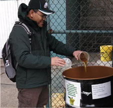 Father Didik of St. Thomas Aquinas church is one of the 15 Barrel Keepers who manage the system of oil collection barrels. The oil he's pouring will become biofuel, compost, and soap.