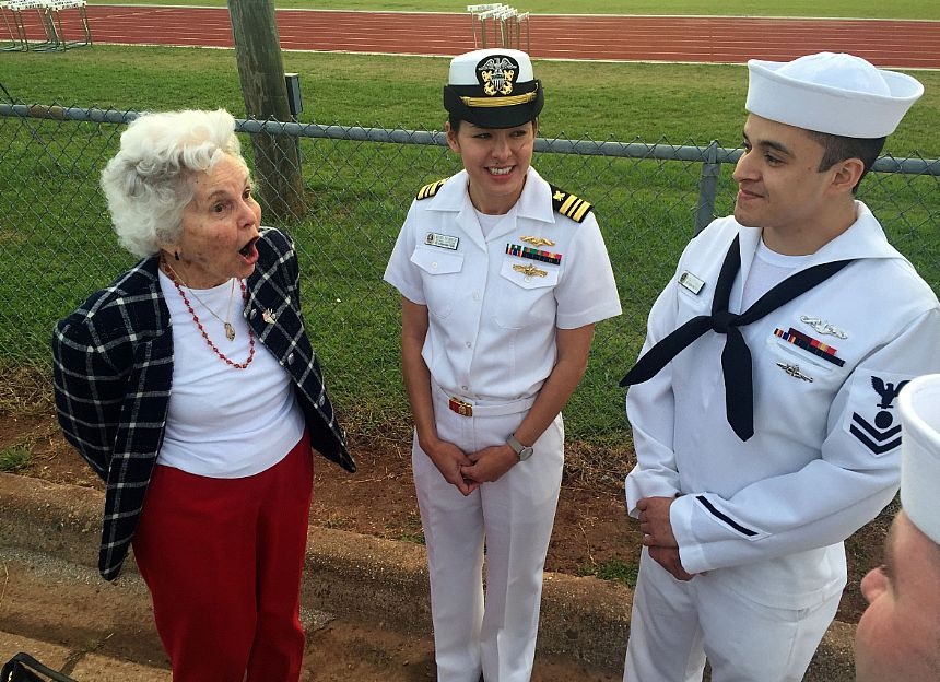 BOSSIER CITY, La. (April 28, 2015) Mary Melson, a former Navy Women Accepted for Volunteer Emergency Service (WAVES), shares a story with Lt. Cmdr. Maura Thompson and other Sailors assigned to the ballistic-missile submarine USS Louisiana (SSBN 743) during the Bossier City, Shreveport Navy Week's Navy Night at Airline High School. Navy Weeks focus a variety of assets, equipment and personnel on a single city for a week-long series of engagements designed to bring America's Navy closer to the people it protects, in cities that don't have a large naval presence. U.S. Navy photo by Mass Communication Specialist 1st Class Chris Fahey.