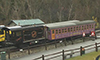 Photo of a locomotive engine carrying passenger cars.