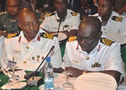 COTONOU, Benin - Nigerian Navy Rear Admiral E.O. Ogbor, chief of Training and Operations, Naval Headquarters, reviews a Memorandum of Understanding while other delegates look on during the Economic Community of Central African States (ECCAS) and Economic Community of West African States (ECOWAS) Maritime Safety and Security Conference held in Cotonou, Benin, March 26-29, 2012.  More than 250 representatives from more than 20 African nations attended the conference, which was held to facilitate cooperation between both African communities in order to provide regional maritime security in the Gulf of Guinea. The event was organized and facilitated by U.S. Africa Command and Africa Center for Strategic Studies. (U.S. AFRICOM photo by Staff Sergeant Olufemi A. Owolabi)