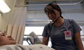 A registered nurse tends to a patient May 3. 