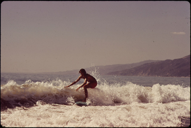 DOCUMERICA: Surfing Along Malibu Beach, California. 10/1972 by Erik Calonius.