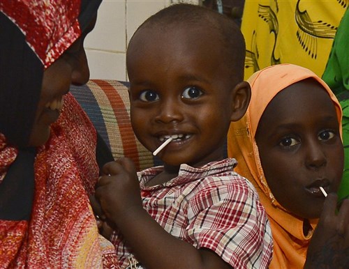 A child eats a lollipop after a medical checkup at the Ali Sabieh Medical Clinic in Djibouti, Africa, Sept. 12, 2015. The 404th Civil Affairs Battalion team, assigned to Combined Joint Task Force-Horn of Africa, partnered with Djibouti’s Ministry of Health to deliver specialty medical care and medication for Djiboutians. (U.S. Air Force photo by Senior Airman Nesha Humes