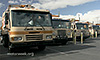 Photo of solid waste trucks parked in a row