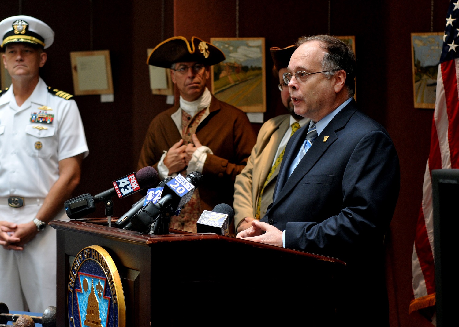 Harrisburg Pa. (July 1, 2015) -- Samuel Cox (center left), Director of the Naval History and Heritage Command, speaks during a ceremony July 1 where the City of Harrisburg formally returned artifacts and timber recovered from Revolutionary War-era schooner Royal Savage to the Navy. Royal Savage served in the American Lake Champlain Squadron under Benedict Arnold during the American Revolution. U.S. Navy photo by Mass Communication Specialist 2nd Class Eric Lockwood. Collection: NH 56467-KN