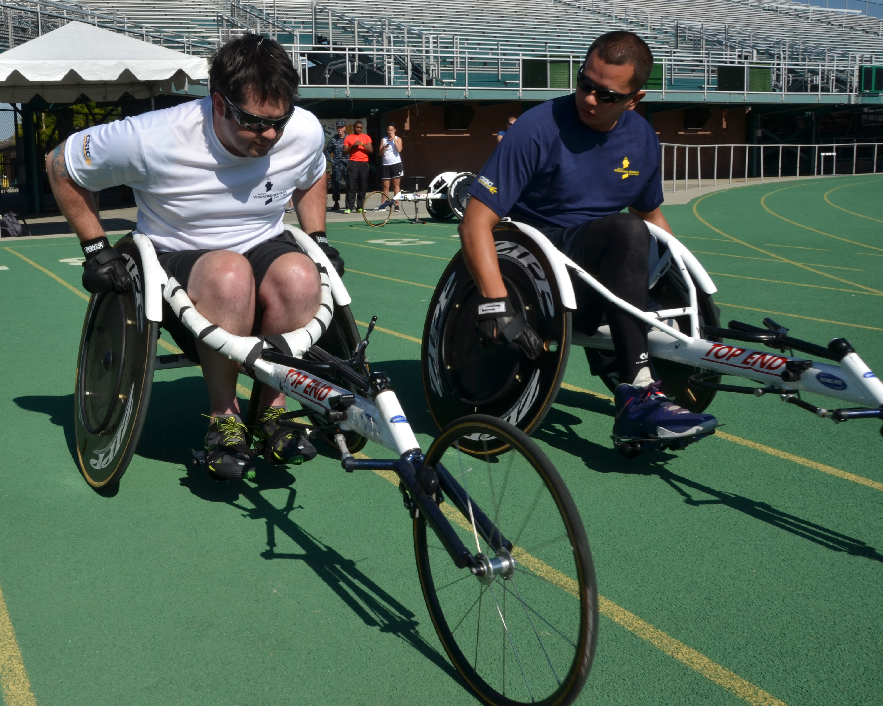Explosive Ordnance Disposal Senior Chief Austin Reese (left) and another athlete begin a practice run on their racing wheelchairs during the Wounded Warrior Navy Trials in 2014. U.S. Navy photo by Mass Communication Specialist 1st Class Erik Wehnes.