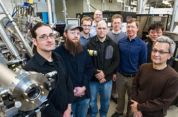 Photo of a group of men standing in a laboratory setting