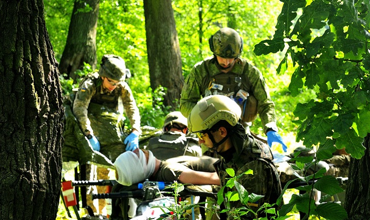 Ukrainian medics treat a simulated casualty during the culminating training event at the International Peacekeeping and Security Center. Soldiers from the United States Army Security Assistance Training Management Organization and instructors from the Army Medical Department in Fort Sam Houston, Texas taught a three-month long combat medic instructor course. (Army photo by Capt. Scott Kuhn)