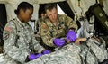 New York Army National Guard 1st Lt. Mercy Ukpe (left) and Sgt. Shawn Wilson, assigned to Headquarters Co., 1st Battalion, 69th Infantry, assess a Soldier for medical care during a mass casualty exercise at the Army's Joint Readiness Training Center.